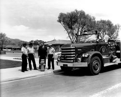 Unidentified City of Santa Rosa official and three firemen with a Santa Rosa Fire Department truck at Oakmont, Santa Rosa, California, 1964