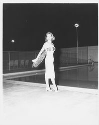 Chonne Patton, Miss Sonoma County, models a white dress with a leopard-print scarf in the Aqua Varieties fashion show at the Swim Center, Santa Rosa, California, 1959