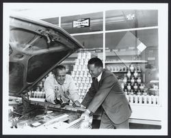 Art Lindberg and John Smath looking under the hood of a car at Smitty's Shell Service, Santa Rosa, California, 1966