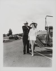 Santa Rosa Fire Chief George H. Magee places a fireman's helmet on Sandra Duden's head, Santa Rosa, California, 1958