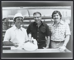 Three men with cheese at the Sonoma Cheese Factory, Sonoma, California, 1978