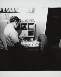 Unidentified man testing a tire at Downey Tire Center, Santa Rosa, California, 1971