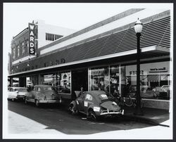 Wrecked Volkswagen advertising Bud Leete Body Shop in front of Montgomery Ward, Santa Rosa, California, 1961