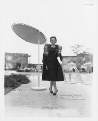 Black coat with a fur stole modeled in the Dramatic Moods of Autumn fashion show, Santa Rosa, California, 1959