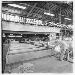 Workers cutting metal framing members to size at Speedspace Corporation, 920 Shiloh Road, Windsor, California, 1971