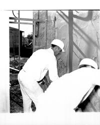 Applying Calaveras Plastic to exterior of the Santa Rosa Garden Apartments