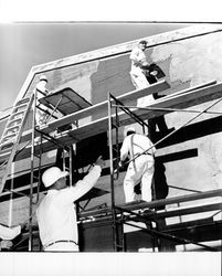 Applying Calaveras Plastic to exterior of the Santa Rosa Garden Apartments