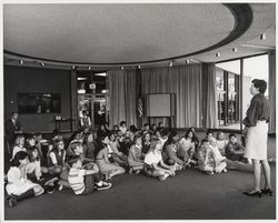 Molly McDermott speaking to a group of children in the Forum Room