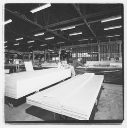 Worker cutting subflooring at Speedspace Corporation, 920 Shiloh Road, Windsor, California, 1971