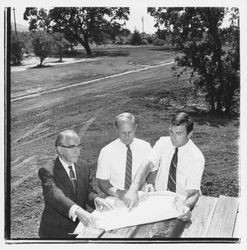 Three men looking at plans for the Tanglewood subdivision, Santa Rosa, California, 1971