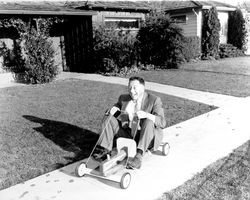 Adult riding a Ram Rod Coaster, Santa Rosa, California, 1958