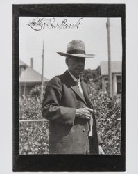 Luther Burbank wearing a straw hat in his garden