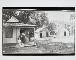 People sitting on the porch of an unidentified resort