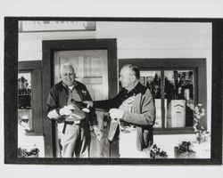 Frank Vannucci and Elmo Martini sharing a bottle of wine at Martini and Prati