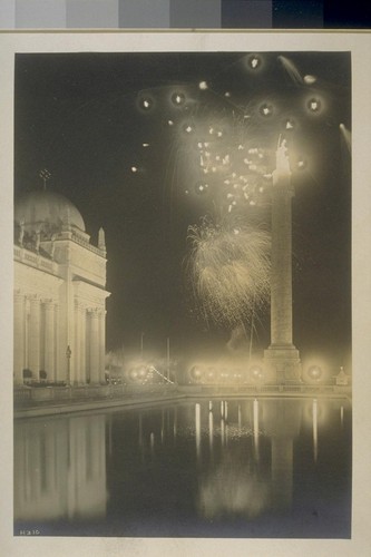 H310. [Fireworks display. Court of the Universe. Column of Progress, right, with "The Adventurous Bowman" illuminated atop.]