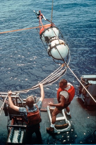 Walter Munk (right) at work, assisting in deployment of scientific equipment