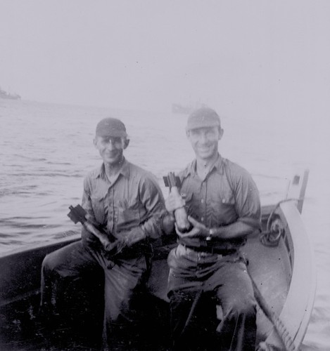 Walter Munk (right) posing with mini-chargers near Bikini Atoll during the atomic testing