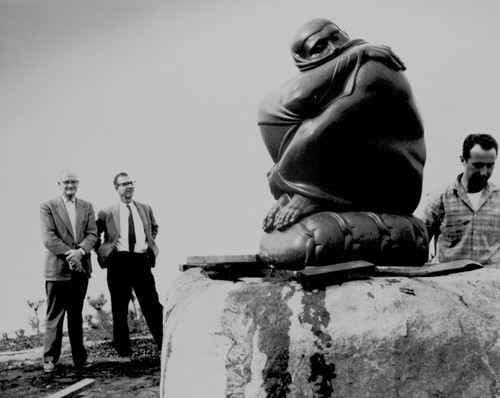 Cecil H. Green (left) and Walter Munk (hands on his hips) watch installation of Spring Stirring sculpture at Scripps Institution of Oceanography, near the Institute of Geophysics and Planetary Physics