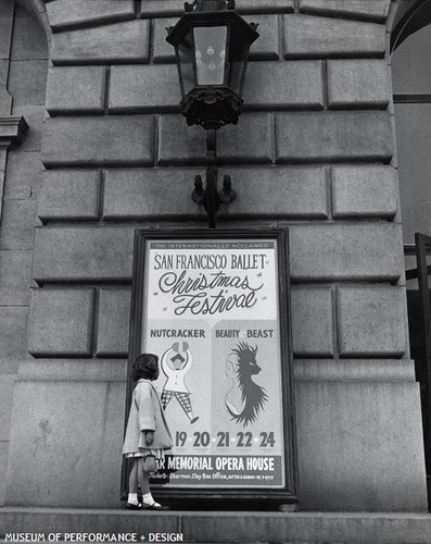 Child in front of a promotional poster for Christensen's Beauty and the Beast and Nutcracker, circa 1966