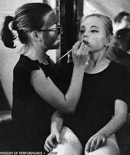 Child dancer applying makeup to a fellow child dancer preparing for Christensen's Nutcracker, 1954