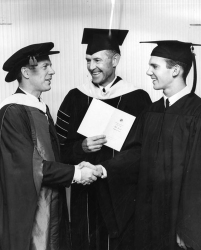 Dr. Taylor, left, and Dr. Prator, center, greet graduates