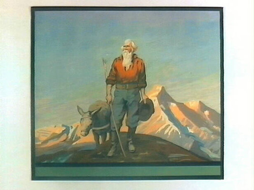 Stock label: man on mountaintop with walking stick, hat and donkey