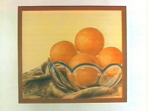 Stock label: glass bowl of oranges on a blanket