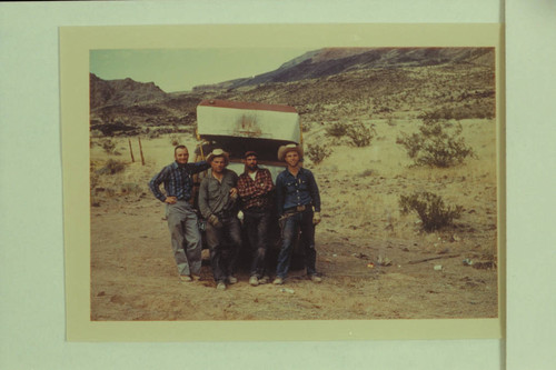 Arizona Power Authority crew with 16' Smith-Craft at the rim of Whitmore Wash: Roy Klinger- boat pilot, Ben Bundy- supply man, Lavay Bundy- cook, Bundy- supply man