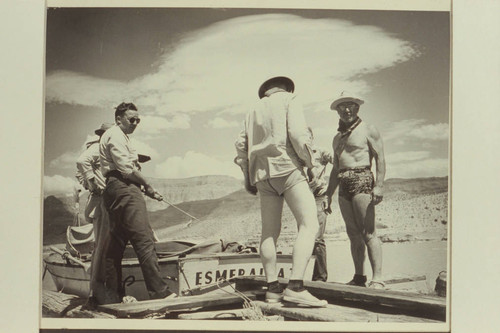 Park Ranger Fred [blank] holds a stern line of the "Esmeralda II" as she is being prepared for docking at Pierces Ferry. End of first motor traverse of the Grand Canyon