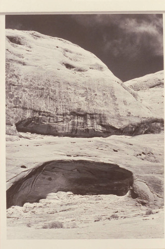 Caves west of Schock Trail, near Mile 111, North Bank. Upper cave contains big slab with early inscriptions