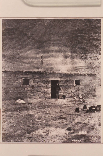 James S. Hogue standing in doorway of fort at Lees Ferry