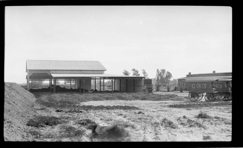 Buildings with two unhitched Imperial Ice wagons outside