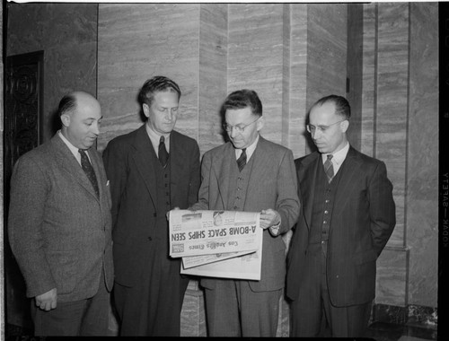 The four Edison engineers who worked on the Manhattan Project posed in the lobby of the Edison Building after the lifting of wartime restrictions on discussion of their work. This newspaper headline, "A