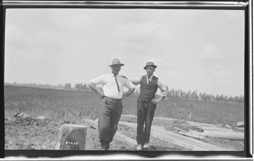 Two inspectors standing near the well at Chino Substation