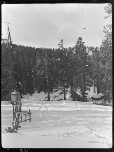 Weather station setup in open field covered with snow