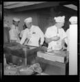 General Electric representatives demonstrating commercial electric cooking equipment at a promotional event