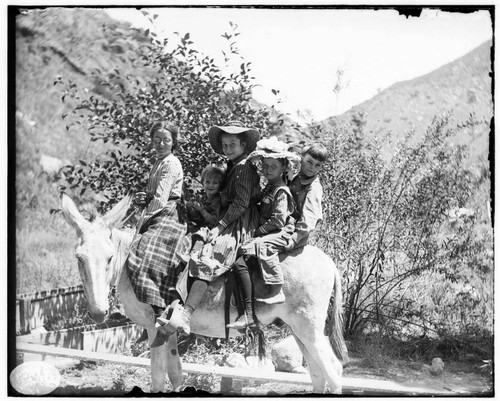 The operator's children riding a mule at Mill Creek #3 Hydro Plant. This image is almost exactly the same as that of G-