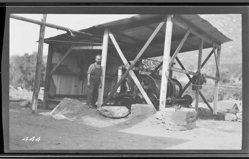 A man standing outside the hut which is housing the hoist at Kaweah #3 Hydro Plant