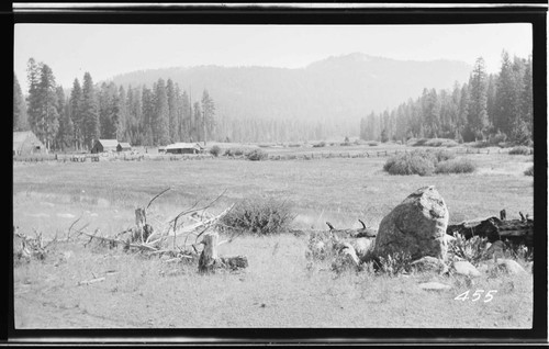 Ranch in a canyon surrounded by mountains and forest