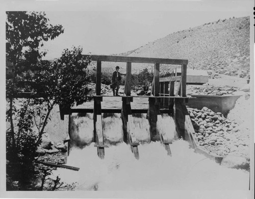 Chief Engineer Charles O. Poole looking at the dam at the intake to Plant Four on Bishop Creek, 1905