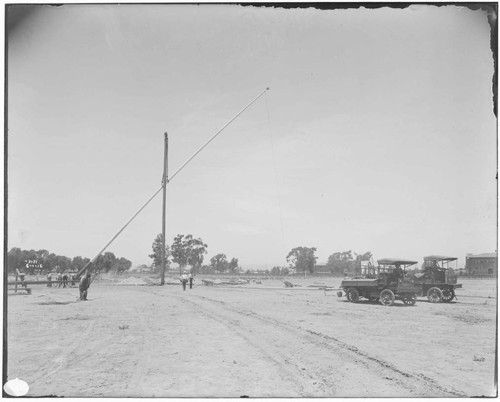 Erecting flagpole at Exposition Park [lifting]