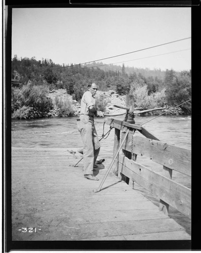 A man working on the ferry on the Pitt River for the Mount Shasta Power Company