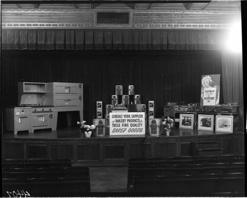 Display of commercial restaurant cooking equipment and food products on the stage the G.O. auditorium