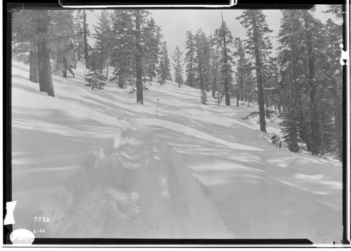 Big Creek, Florence Lake Dam - Sled transportation track on road above Huntington Lake, with storm guide pole in middle distance