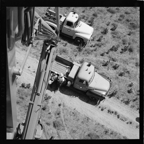 View from raised bucket of desert and truck below