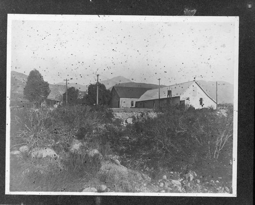 A couple of houses surrounded by the hydro plant buildings