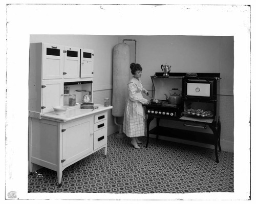 Hughes range and water heater in studio kitchen with two women cooking