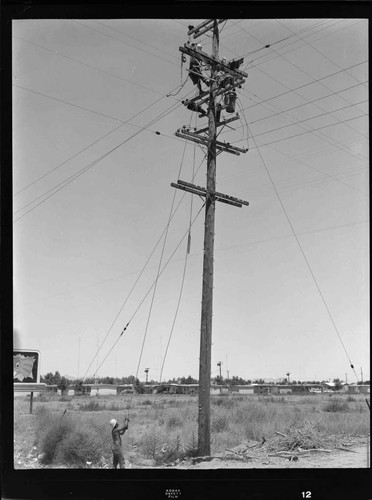Linemen working at top of transformer pole