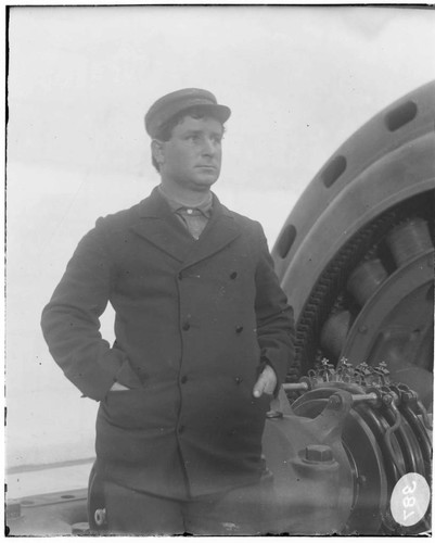 B.F. Pearson standing by a generator at Santa Ana River #1 Hydro Plant