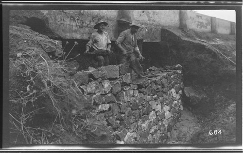 Two men repairing a ditch at Kaweah #3 Hydro Plant